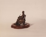 Snapshot of Lincoln Seated at Table Statuette