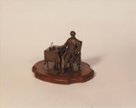Snapshot of Lincoln Seated at Table Statuette