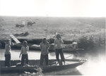 Four people standing up on a boat