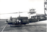 Helicopter sitting with two men inside