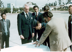 Sonny Montgomery and 4 other men gather around to sign a document