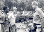 Sonny Montgomery casually talks with 2 unidentified soldiers