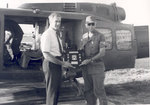 Sonny Montgomery displaying award with unidentified soldier