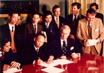 Sonny Montgomery gathered with foreign leaders signing documents