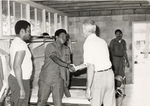 Sonny Montgomery greets 3 African-American soldiers in a barracks
