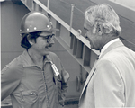Sonny Montgomery speaks to a man in a worker's helmet