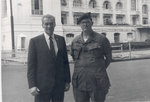 Sonny with soldier in front of a building under construction