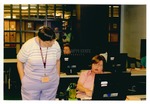 Lynee Mueller assisting Cindy Harris in a workshop by Mississippi State University Libraries
