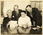 Gale Carr, W. L. Kearney, and Two Unidentified Men Study A Document