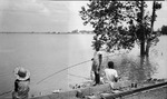 Family fishing by floodwaters