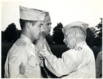 Solider being decorated by Charles Johnson Faulk Jr.