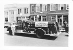 Fire truck with dealer's banner on side on Main Street