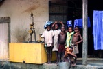 Children at a Village Gas Station by Jerry Boyd Jones