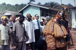 A Crowd Following a Person Dressed in a Ceremonial Costume by Jerry Boyd Jones