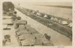 Houses Partially Under Water and Tents Lining the River