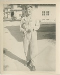 A Man in Coveralls Outside the Barracks