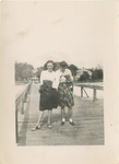 Johnny Sue Long and Martha Carlmikel Standing on a Pier