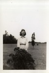 Woman Standing Behind a Bush