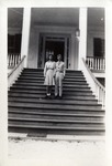 United States Air Force Airman in Uniform and a Woman Standing on Entrance Steps