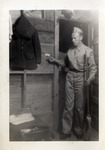 United States Air Force Airman Holding a Broom Inside a Bunkroom