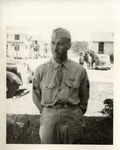 United States Air Force Airman in Uniform, Standing Outside in Front of the Barracks, Hands Behind His Back