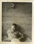 A Man in Coveralls on a Cot