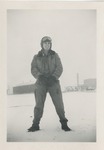 Man Wearing Snowsuit and Goggles in a Snowy Parking Lot