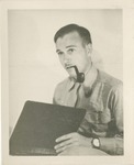 United States Air Force Uniformed Man With a Pipe in His Mouth, Holding a Book