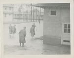 Men in Raincoats Wading Through Flooded Streets at the Keesler Field Barracks (Keesler Air Force Base)
