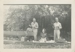 Two Uniformed Airmen and a Woman at a Picnic