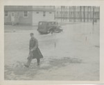 Man in a Raincoat Wading Through Rain Flooded Streets