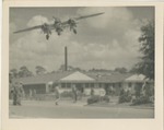 An Airplane Flying Low Over a Building