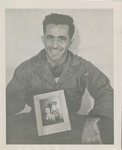 Dark Haired Man Holding a Photograph