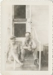 Two Men Sitting on the Entrance Steps to the Barracks