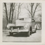 A Mid-Twentieth Century Car Parked in a Driveway