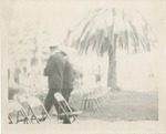 Two Uniformed Men Walking an Aisle Between Chairs