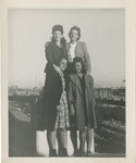 Four Women in Dresses Posing at the Beach