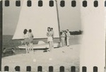 People Standing in Front of a Sailboat