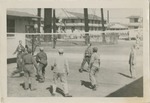 Men in Coveralls Playing Game at Barracks