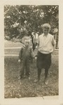 Two Children In Front of a Bush