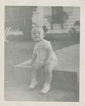 Baby Sitting on a Sidewalk