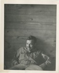 A Man in Coveralls on a Cot