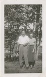 Man and Woman Posing in Front of Trees and Pond