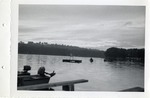 Two Row Boats on the Water Near a Platform