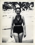 Woman in a Dark Swim Suit on the Beach