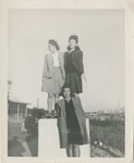 Three Women Posing on a Concrete Pedestal