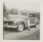Young Girl Leaning Against a Car