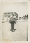 United States Air Force Airman in Uniform, Holding a Duffle Bag at the Barracks