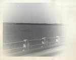 View of a Pier Across the Water from a Bridge