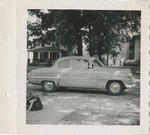 A Mid-Twentieth Century Car Parked in the Street